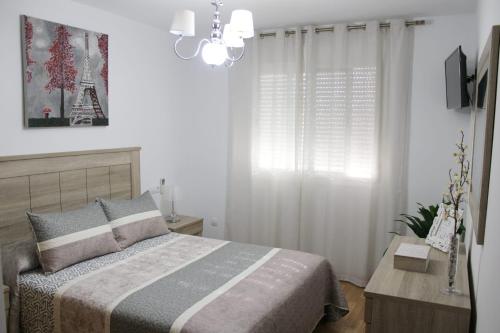 贝莱斯ALMIJARA的一间卧室配有一张床和一个吊灯