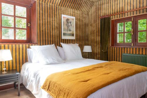 博韦La maison de Michel的一间卧室设有一张大床和两个窗户。