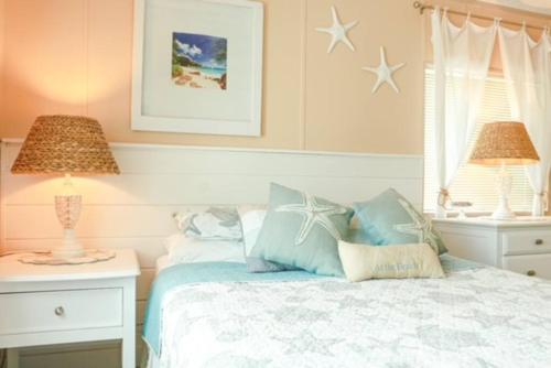 Cudjoe KeyIsland Oasis ~ YOUR Paradise Awaits!的一间卧室配有一张带两盏灯的床,墙上挂着星星。