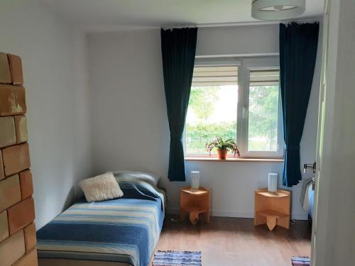 KrasnopolDom na Suwalszczyźnie的一间小卧室,配有床和窗户