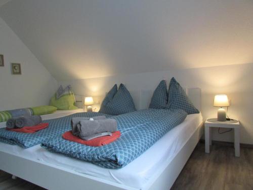 拉赫塔尔Ferienhaus Priller的一间卧室配有一张带蓝色和绿色枕头的床