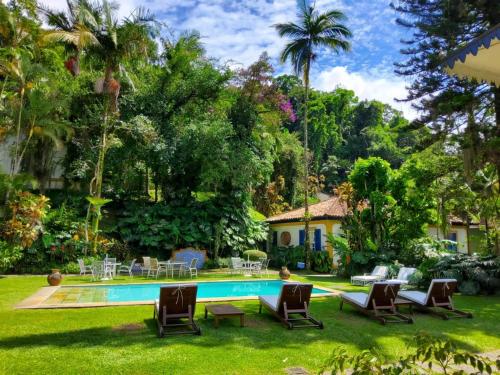 彼得罗波利斯Pousada Vila Brasil的庭院中带游泳池的房子