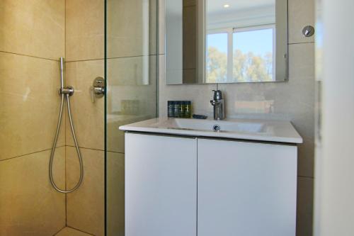 PaphosPhaedrus Living - Seaside Deluxe Flat Harbour 112的浴室配有白色水槽和淋浴。