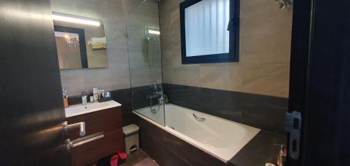 阿加迪尔Appartement luxe Taghazout bay - mer & piscine的带浴缸和盥洗盆的浴室