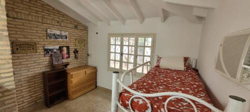 圣贝纳迪诺Los Prados Sanber的一间卧室设有一张床和砖墙