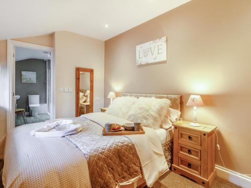 布里真德Caner Bach Lodge的一间卧室配有一张床,一个配有标志的木制梳妆台