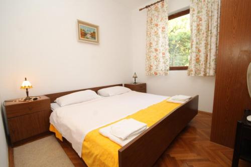 默克斯卡Seaside holiday house Mokosica, Dubrovnik - 8588的卧室配有一张带白色床单的大床和窗户。