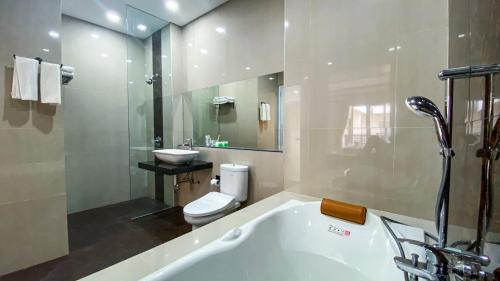 登巴萨Ultimate Residence Bali的带浴缸、卫生间和盥洗盆的浴室