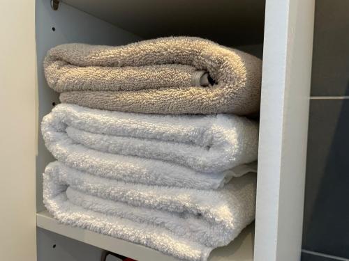 Ostrohe2-Zi Wohnung mit Kingsize-Bett und geschlossenem Parkplatz的衣柜里的白色毛巾堆