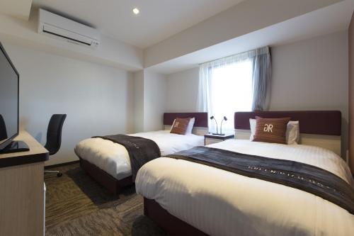 Green Rich Hotel Izumo (Artificial hot spring Futamata Yunohana)客房内的一张或多张床位