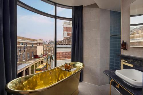 伦敦AMANO Covent Garden的带浴缸的浴室和大窗户