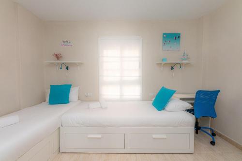 卡亚俄萨尔瓦赫La sonada bright penthouse with views的蓝色调的客房内设有两张单人床。