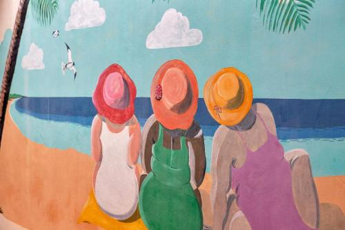 克拉伦代克Kas di Bientu at Windsock Beach的一张四人坐在海滩上的画