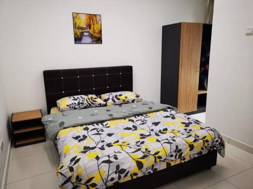 艾尔克如D'sarang Cinta Homestay Swimming Pool Melaka的一间卧室配有一张带黑色和黄色棉被的床