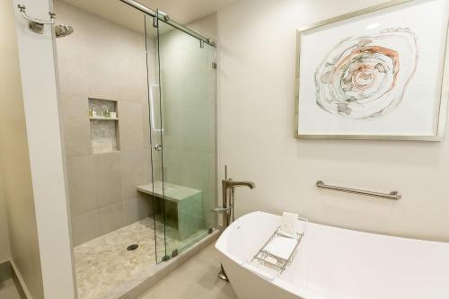 帕克城Deluxe Two Queen Room Hotel Room的一间带玻璃淋浴和水槽的浴室
