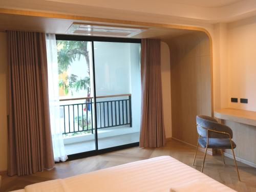 清莱Sann Boutique Hotel的一间卧室设有一张床和一个阳台的窗户。