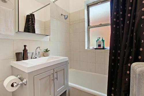 芝加哥1BR Deluxe Apt with Complete Amenities - Campbell 3的浴室配有盥洗盆和浴缸。