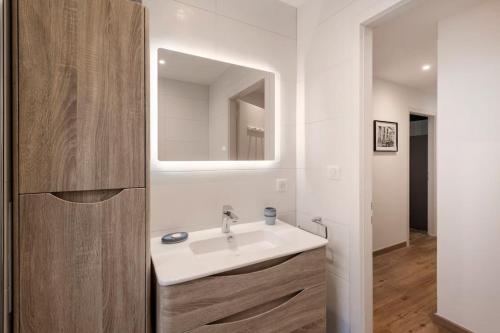 斯特拉斯堡Comme chez vous的浴室设有白色水槽和镜子