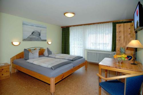 圣布拉辛贝尔维尤酒店的一间卧室配有一张床、一张桌子和一张书桌