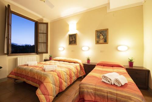 佛罗伦萨佛罗伦萨瓦尔德瑟旅馆的一间卧室配有两张带毛巾的床