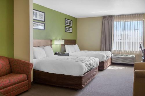 贝克斯菲尔德Sleep Inn & Suites Bakersfield North的酒店客房,设有两张床和一张沙发