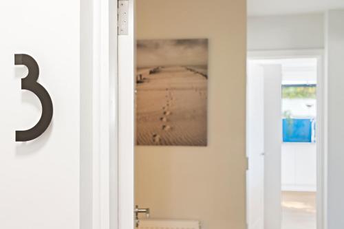 StokeinteignheadStunning Coastal Apartment in Maidencombe with Sea Views & Garden的挂在墙上的有照片的门