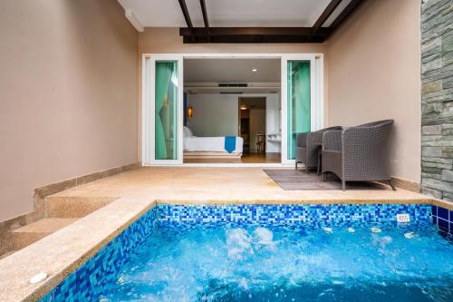 邦涛海滩Hotel COCO Phuket Bangtao - SHA Extra Plus的房屋中间的游泳池