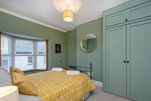 里辛Beautiful Redbrick Home in Ruthin Centre & Parking的一间卧室配有一张床和镜子