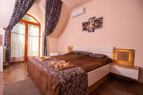 斯拉太阳花酒店的一间卧室设有一张床和一个大窗户