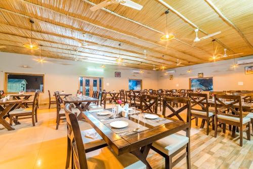 斋沙默尔Bhavya Resort - Luxury Boutique Desert Camp的大型用餐室配有木桌和椅子