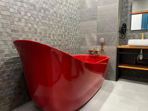第比利斯TownHouse Tbilisi Boutique Hotel的浴室配有红色浴缸及水槽