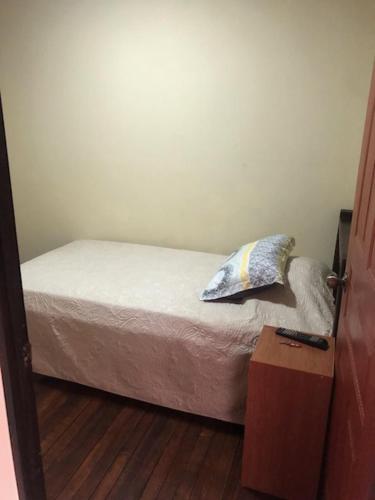阿拉胡埃拉#2 private room close to airport的一间卧室配有一张带枕头的床