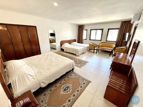 梅克内斯普莱桑斯酒店的酒店客房设有床和客厅。