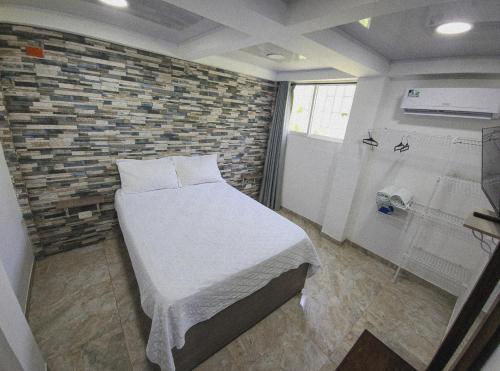 La LomaApartamento Turistico Soul的一间卧室设有一张床和砖墙