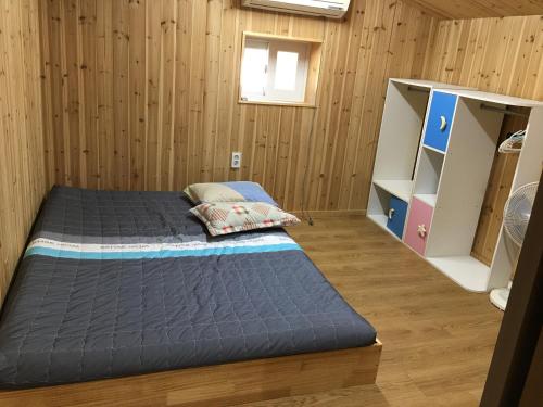济州市Bongcheon Ville的木墙客房的两张床