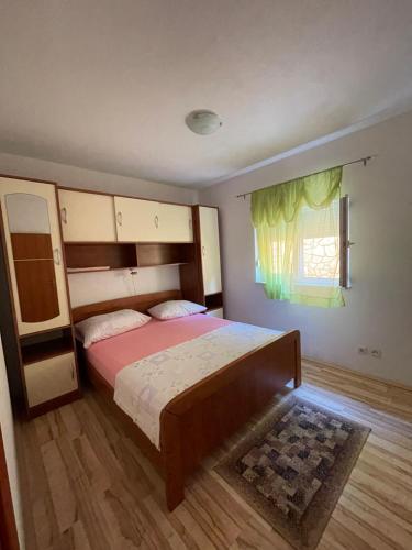 玛里纳Apartman Jukic的一间卧室设有一张大床和一个窗户。