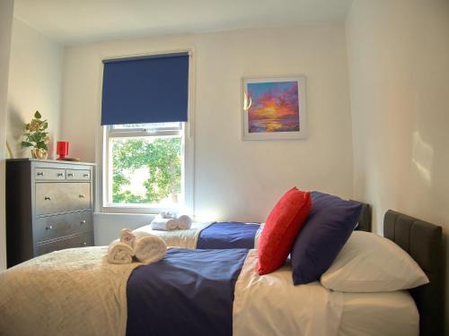 伦敦Lovely Large London Apartment Near Stratford的一间卧室设有两张床和窗户。