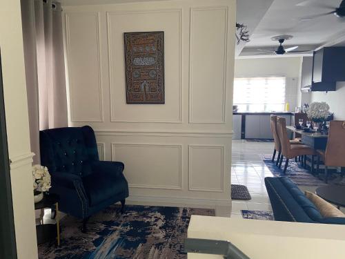 甘榜龙溪Cheerfull3 bedroom townhouse Terrace的客厅配有蓝色椅子和桌子