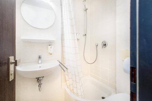 科隆莱奥科隆老城新奇酒店的带淋浴和盥洗盆的白色浴室