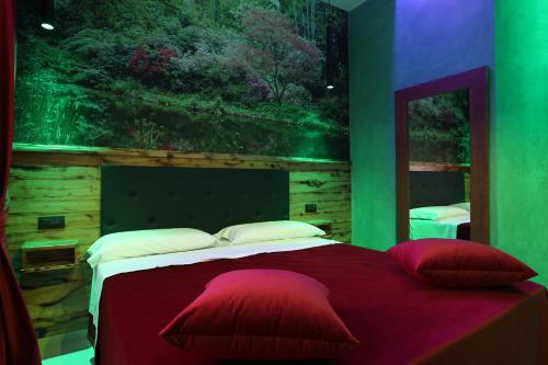 埃博利Alcova Suite&Relax的卧室配有一张大床,墙上挂有绘画作品
