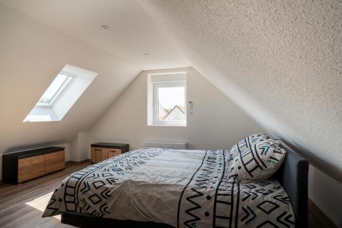 维桑堡Gemütlich 7 - Appartement cosy climatisé的一间卧室设有一张床和两个窗户。