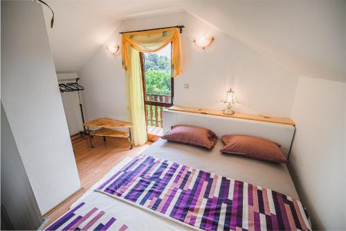 布雷日采Holiday Home Vesna with Sauna的窗户间内的一张带两个枕头的床