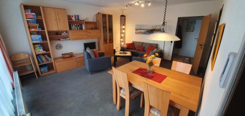 朗格奥Ferienidyll Langeoog的一间带桌子的客厅和一间带沙发的客厅