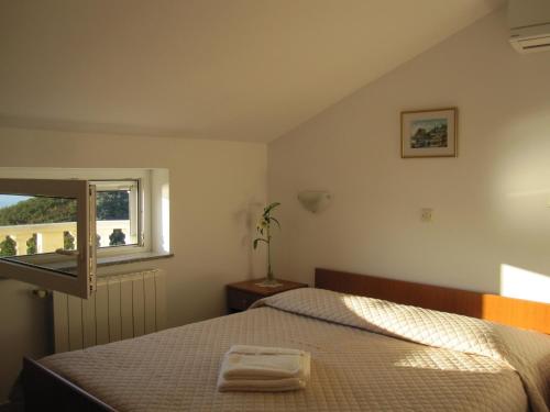 密德维亚Apartments with a parking space Medveja, Opatija - 7721的一间卧室设有一张床和一个窗口