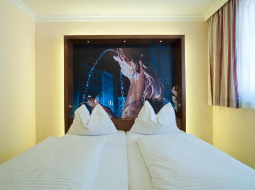 珀斯特绿色酒店 - 100％比奥客房内的一张或多张床位