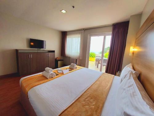 大雅台Tagaytay Hotel SixB的一间卧室配有一张大床,上面有两只泰迪熊