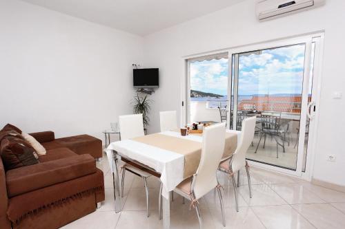 希杰弗朗吉卡Apartments by the sea Seget Vranjica, Trogir - 10328的客厅配有桌椅和沙发