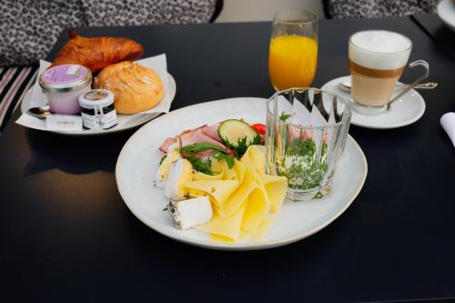 维也纳The Leo Grand的一张桌子,上面放着两盘食物和两杯橙汁
