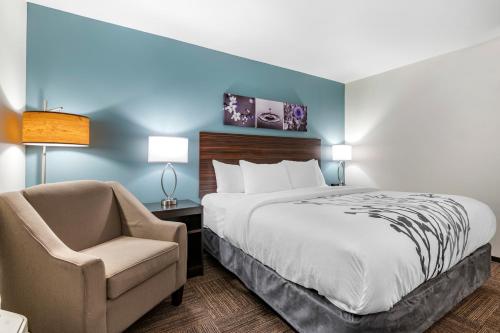 乔治城Sleep Inn的配有一张床和一把椅子的酒店客房