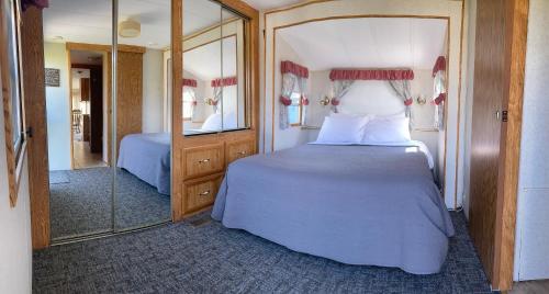 Pelican RapidsPelican Motel的一间卧室配有一张大床和镜子